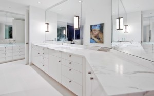 The modern master bathroom, at the Escala penthouse, done in high gloss white lacquer cabinetry, by Pedini